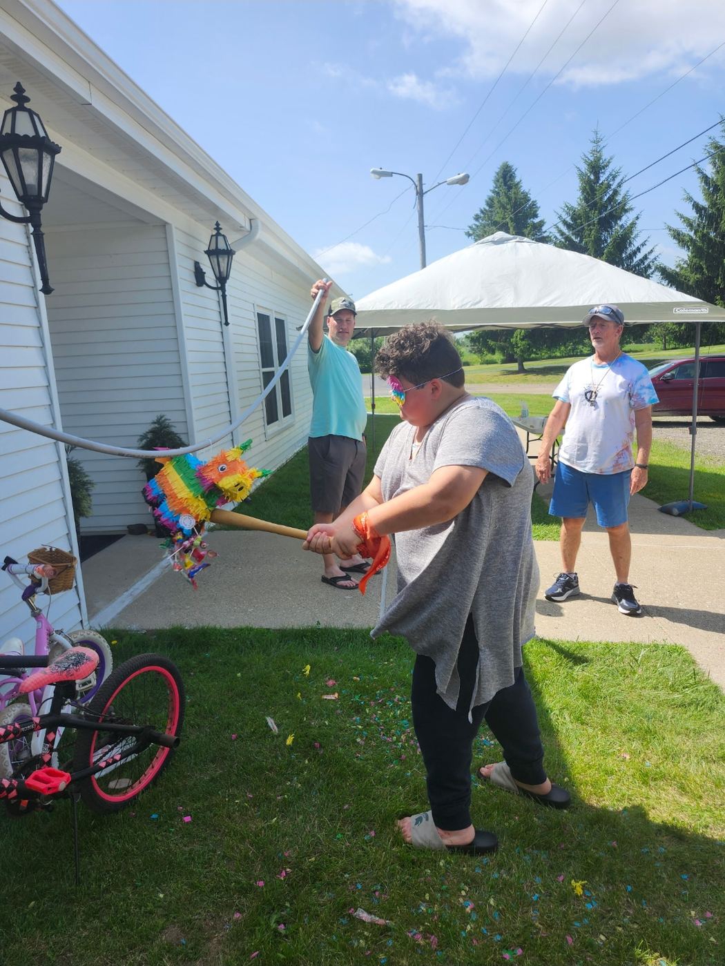 A child hitting the colorful pinata during VBS