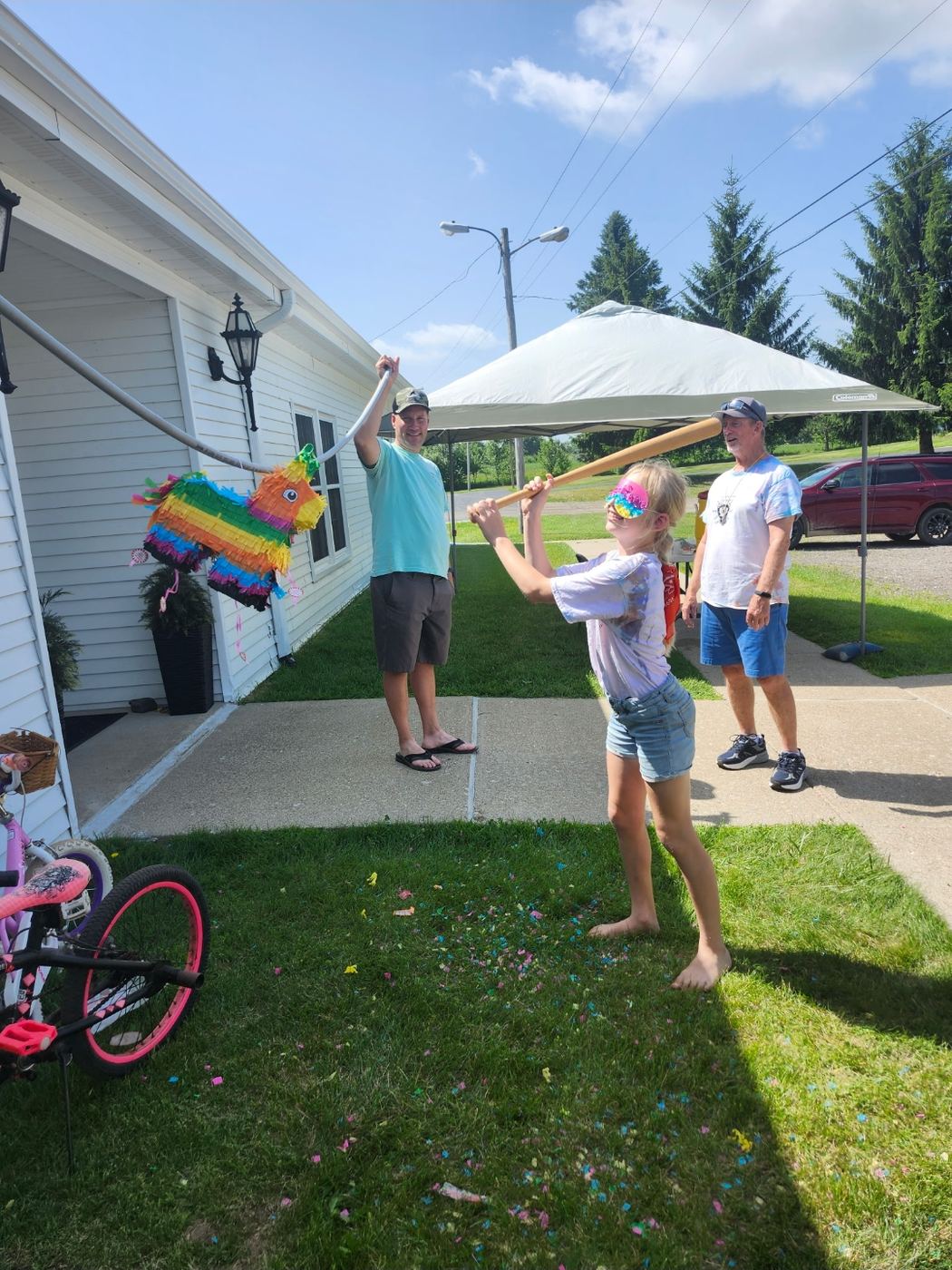 A child wearing a blindfold swinging at the VBS pinata