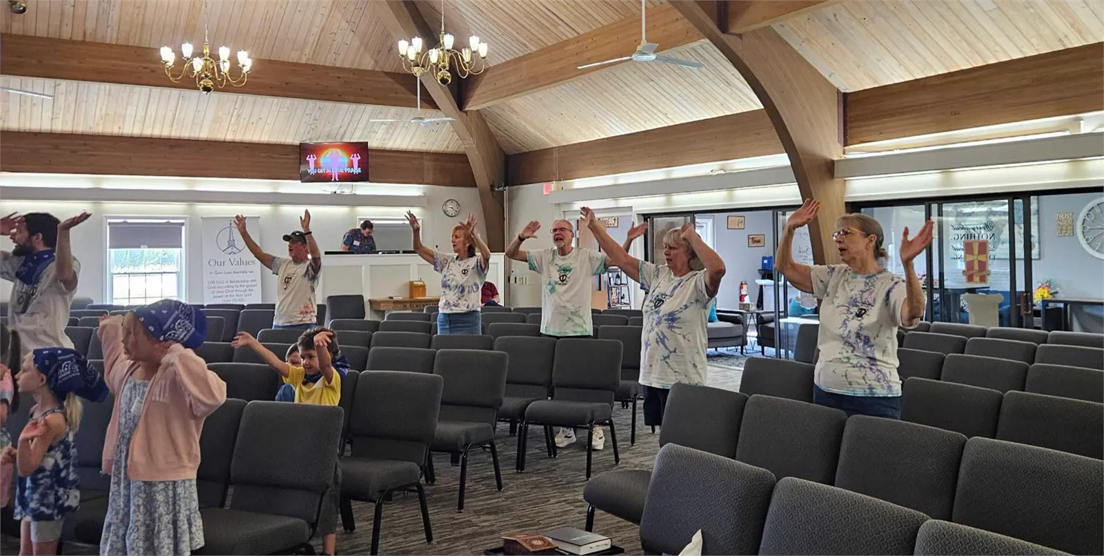 Kids and adults praising God together during VBS 2026